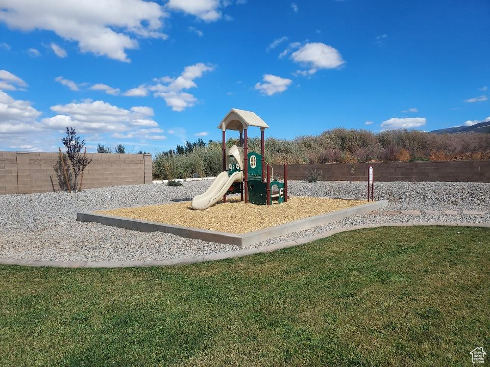 View of play area featuring a yard