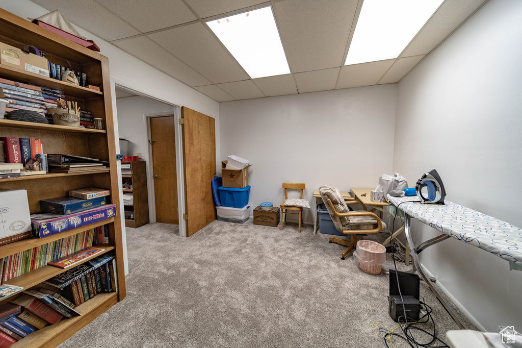 Carpeted home office featuring a drop ceiling