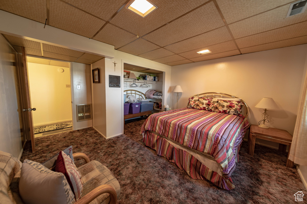 Carpeted bedroom with a drop ceiling