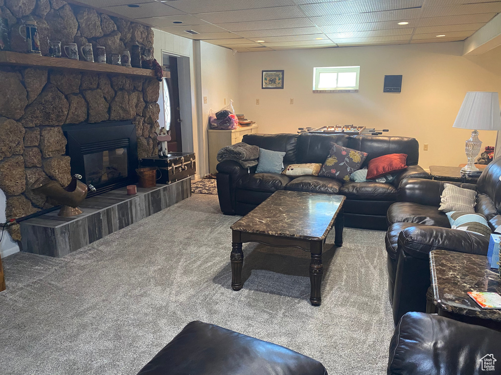 Carpeted living room with a fireplace and a paneled ceiling