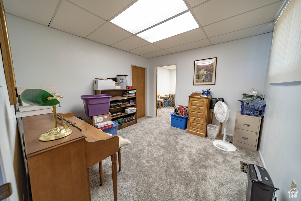 Carpeted office featuring a drop ceiling