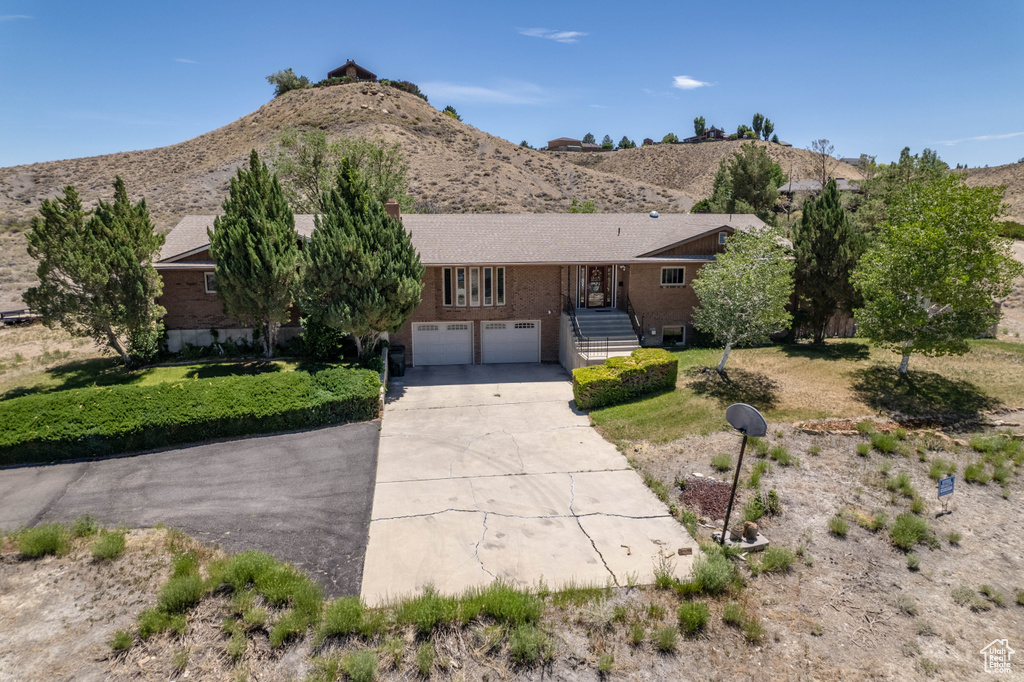 Ranch-style home featuring a garage and a mountain view