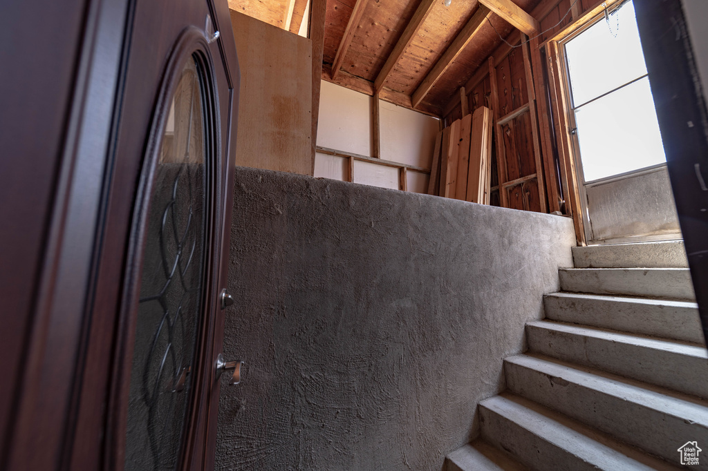 Stairway featuring lofted ceiling