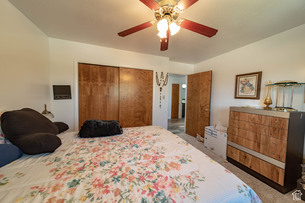 Bedroom featuring a closet, ceiling fan, and carpet floors