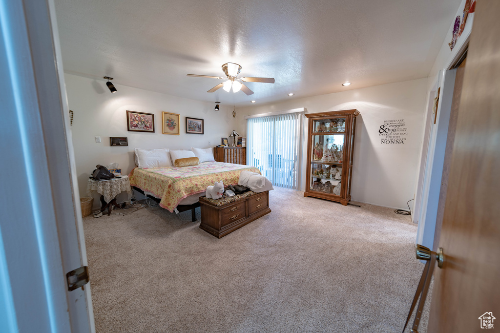 Bedroom featuring ceiling fan and light carpet