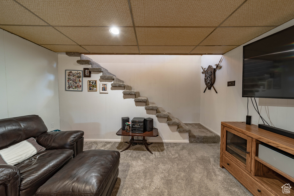 Carpeted living room featuring a paneled ceiling