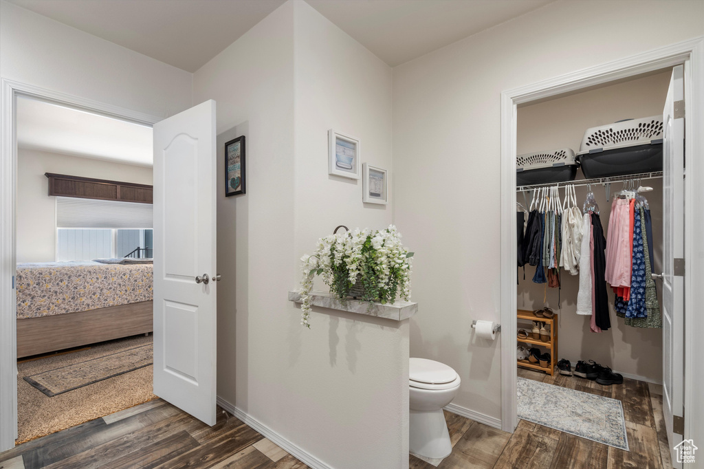 Bathroom featuring hardwood / wood-style flooring and toilet