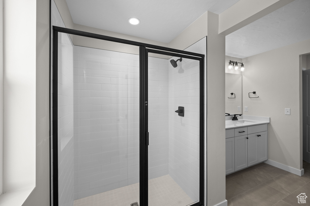 Bathroom with a shower with shower door and vanity