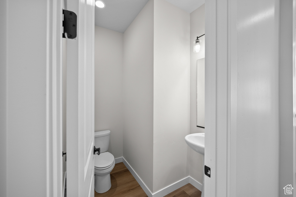 Bathroom featuring wood-type flooring and toilet