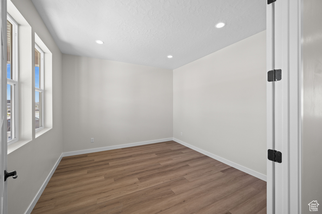 Spare room with hardwood / wood-style floors and a textured ceiling