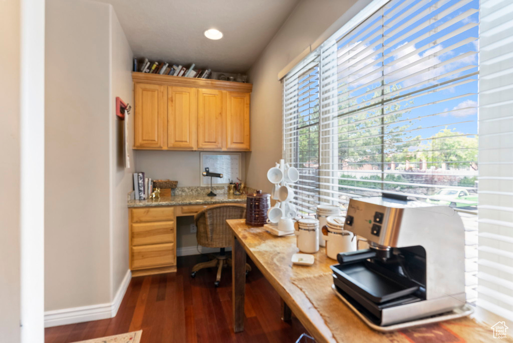 Office featuring hardwood / wood-style floors and built in desk