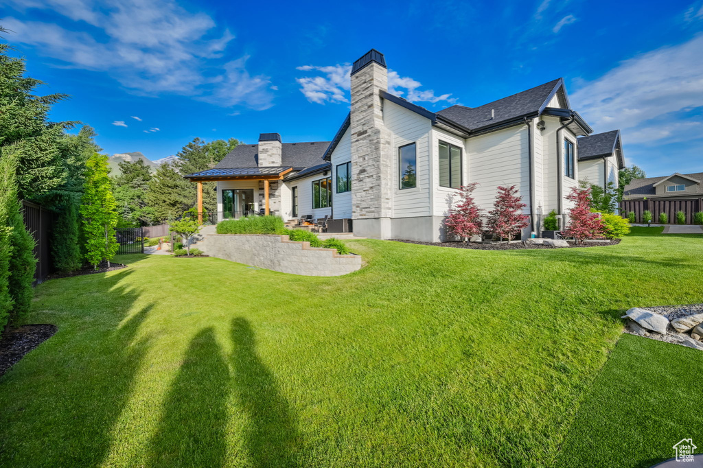 Rear view of house with a lawn