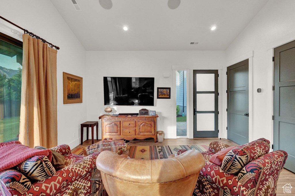 Living room featuring light hardwood / wood-style floors and vaulted ceiling