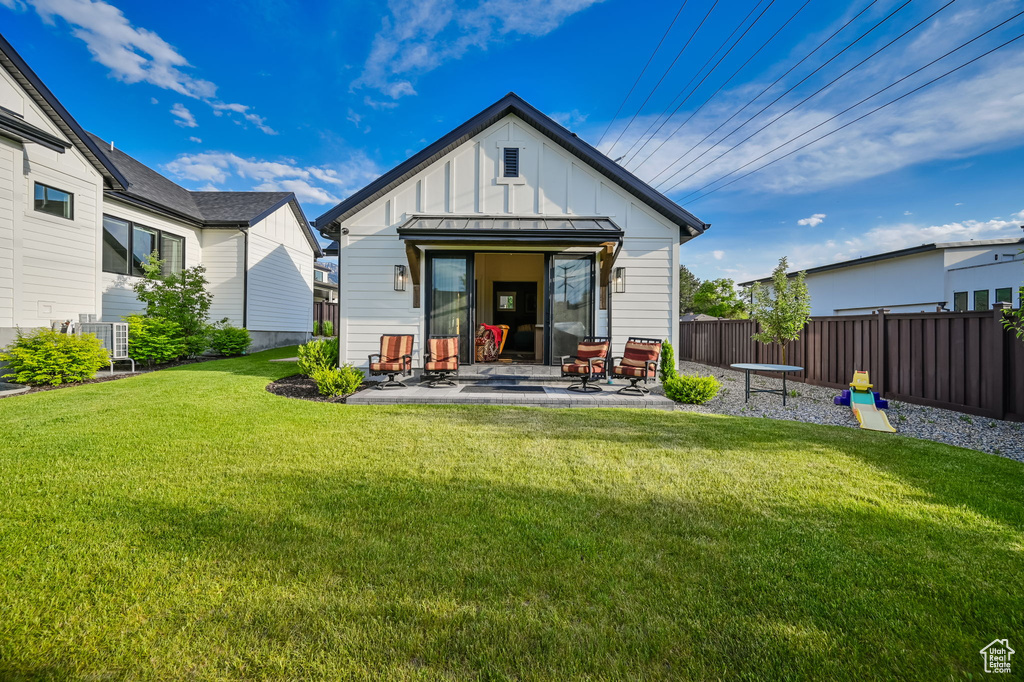 Back of property featuring a patio and a yard