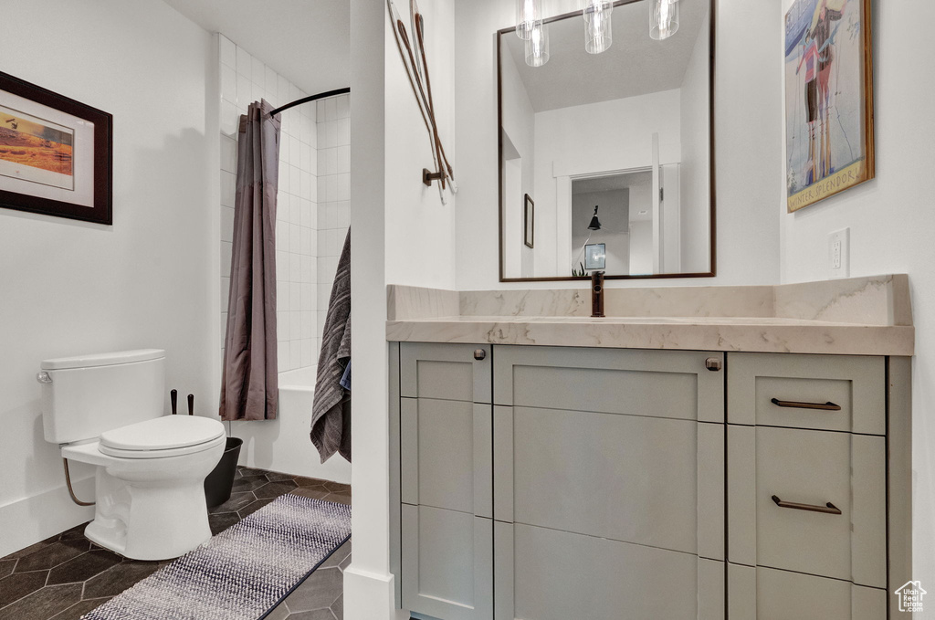 Bathroom featuring tile floors, vanity, and toilet