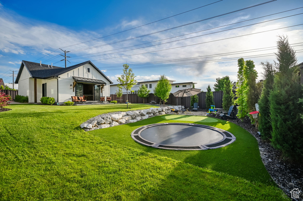 View of yard featuring a trampoline