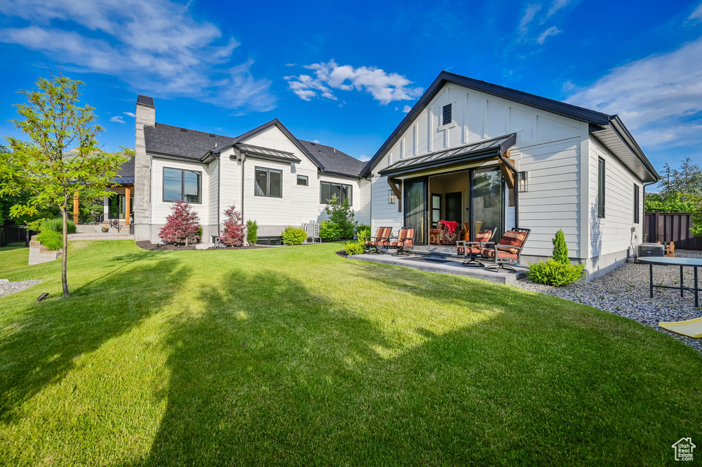 Back of house featuring a patio and a yard