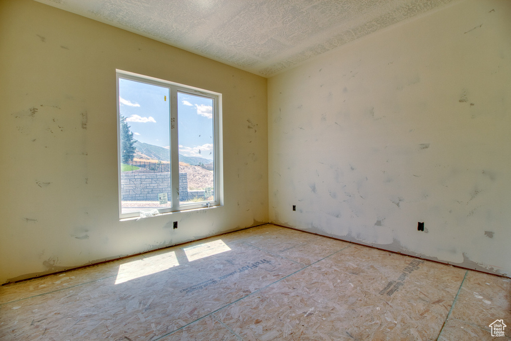 Empty room featuring a textured ceiling