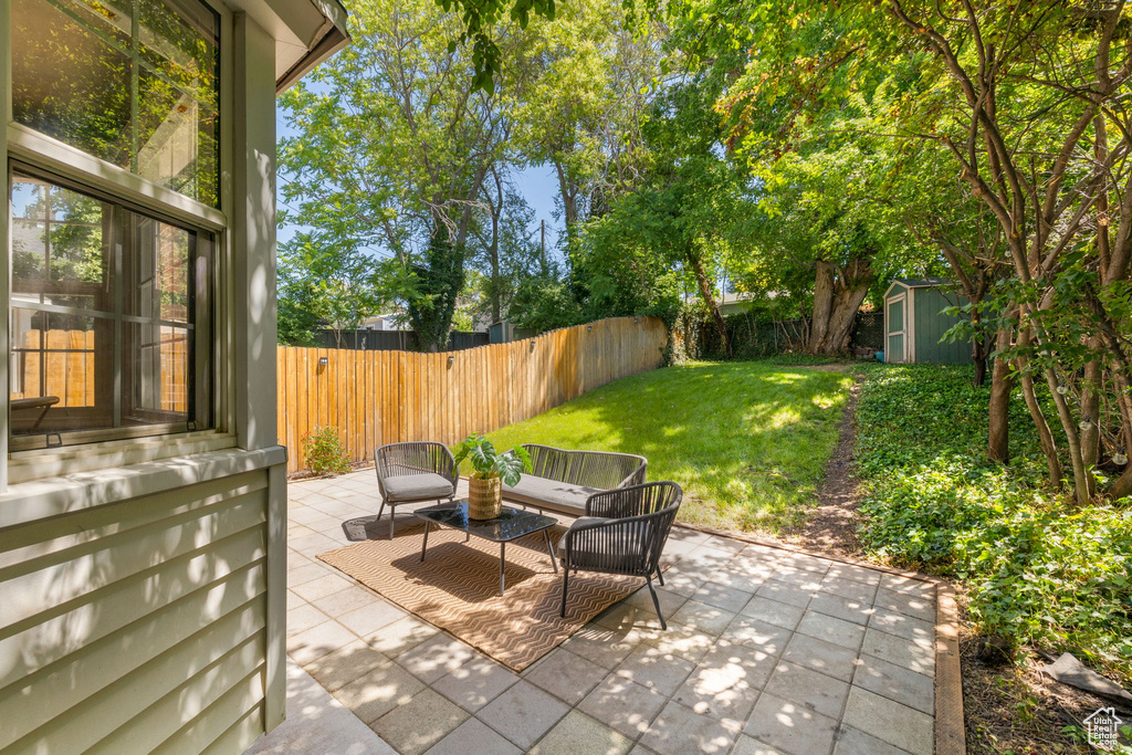 View of patio / terrace with an outdoor hangout area and a shed