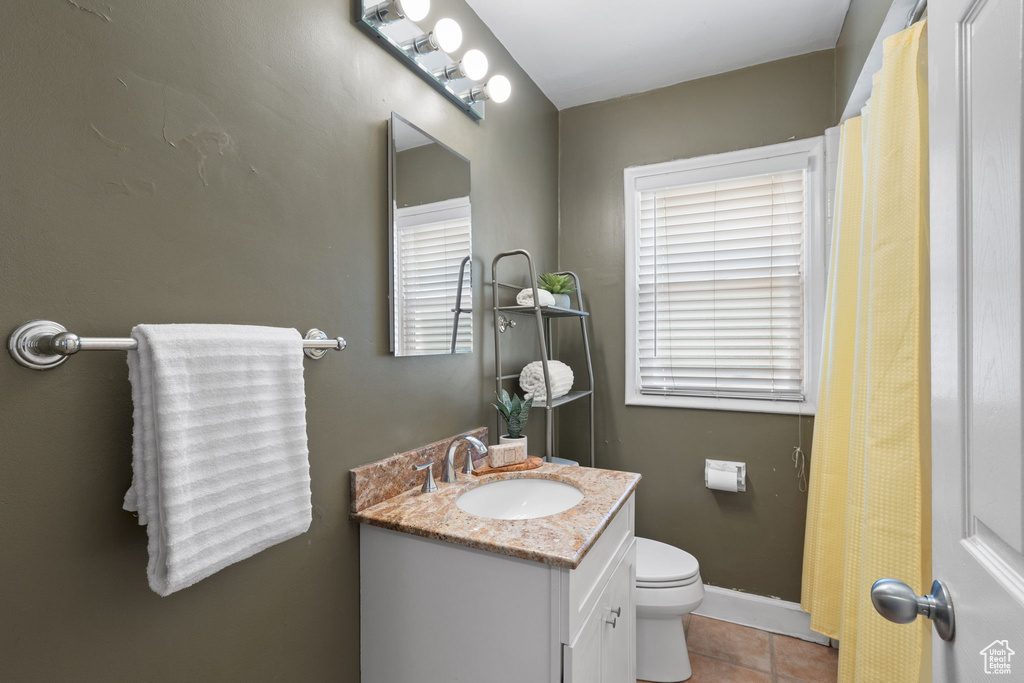 Bathroom with vanity, toilet, and tile floors