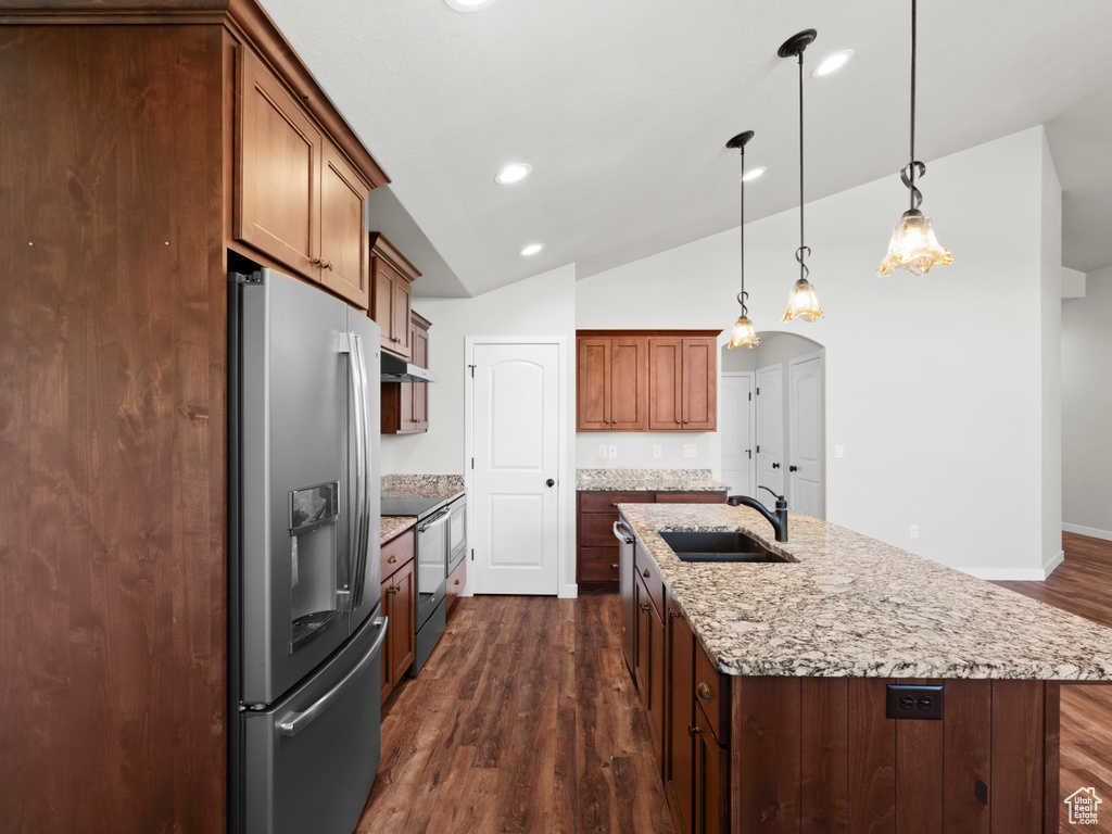 Kitchen with appliances with stainless steel finishes, sink, an island with sink, and dark hardwood / wood-style floors