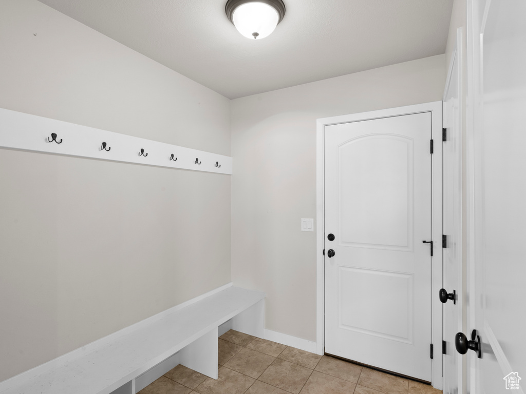 Mudroom featuring light tile flooring