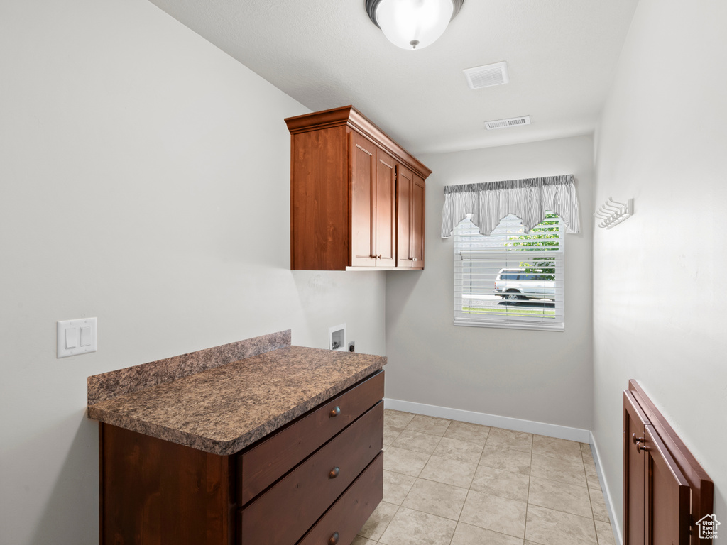 Kitchen with light tile flooring