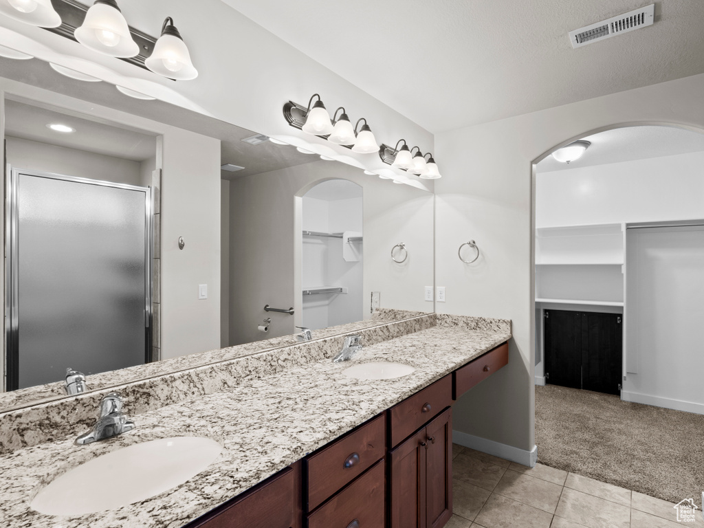 Bathroom with tile floors and double sink vanity