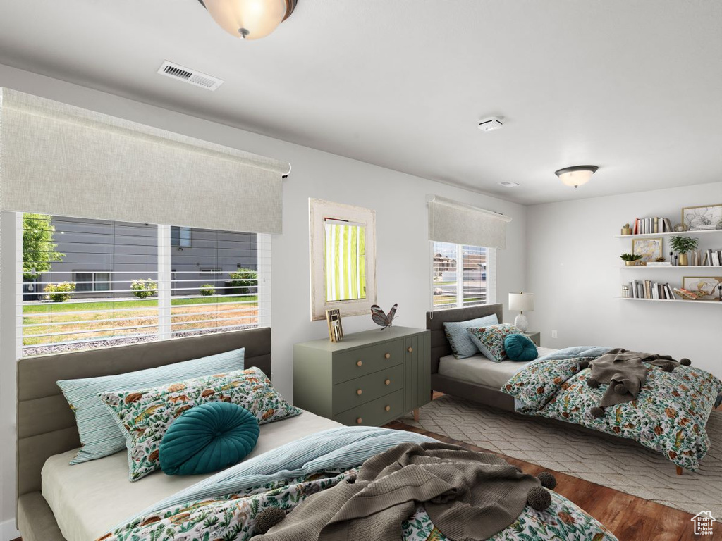 Bedroom featuring light hardwood / wood-style flooring and multiple windows