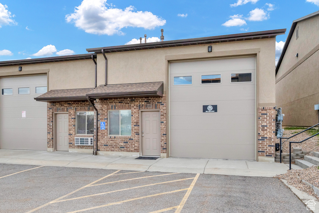 View of building exterior featuring a garage