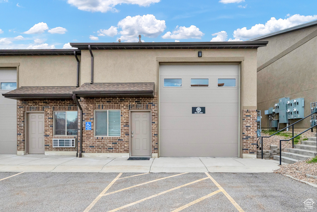 View of building exterior featuring a garage