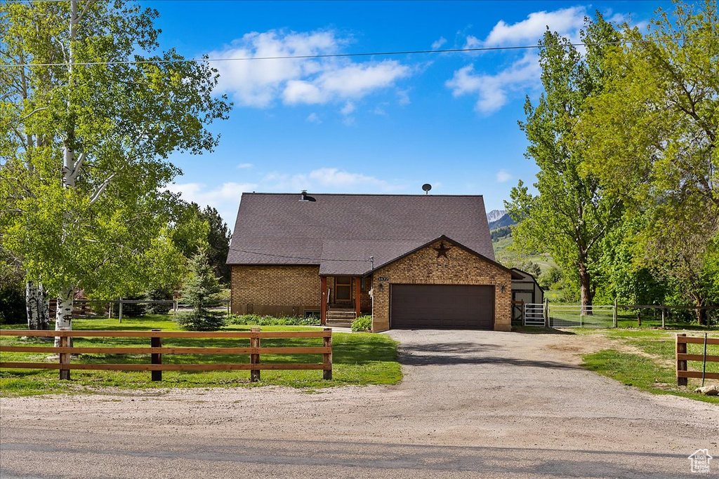 View of front of house featuring a front yard and a garage