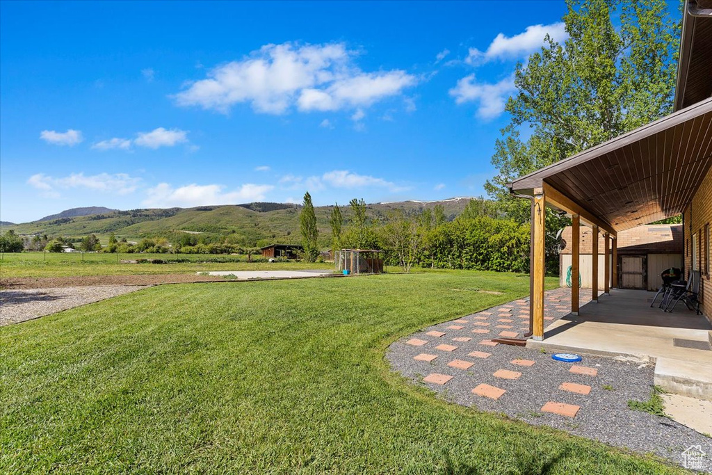 View of yard with a mountain view and a patio