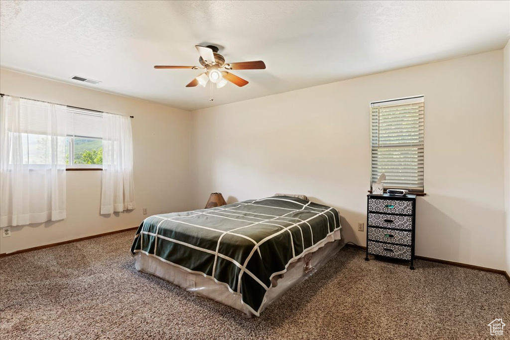 Bedroom with ceiling fan and carpet flooring