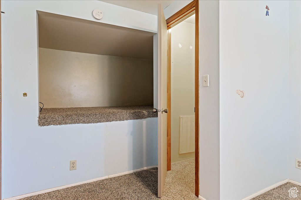 Hallway featuring carpet flooring