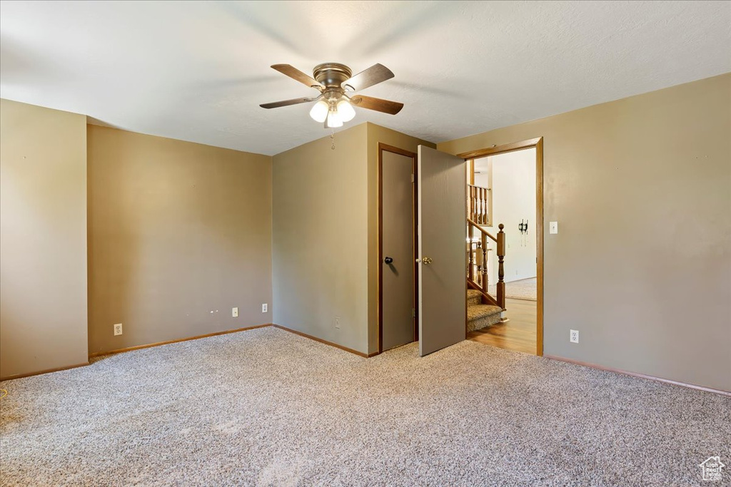 Unfurnished bedroom with carpet and ceiling fan