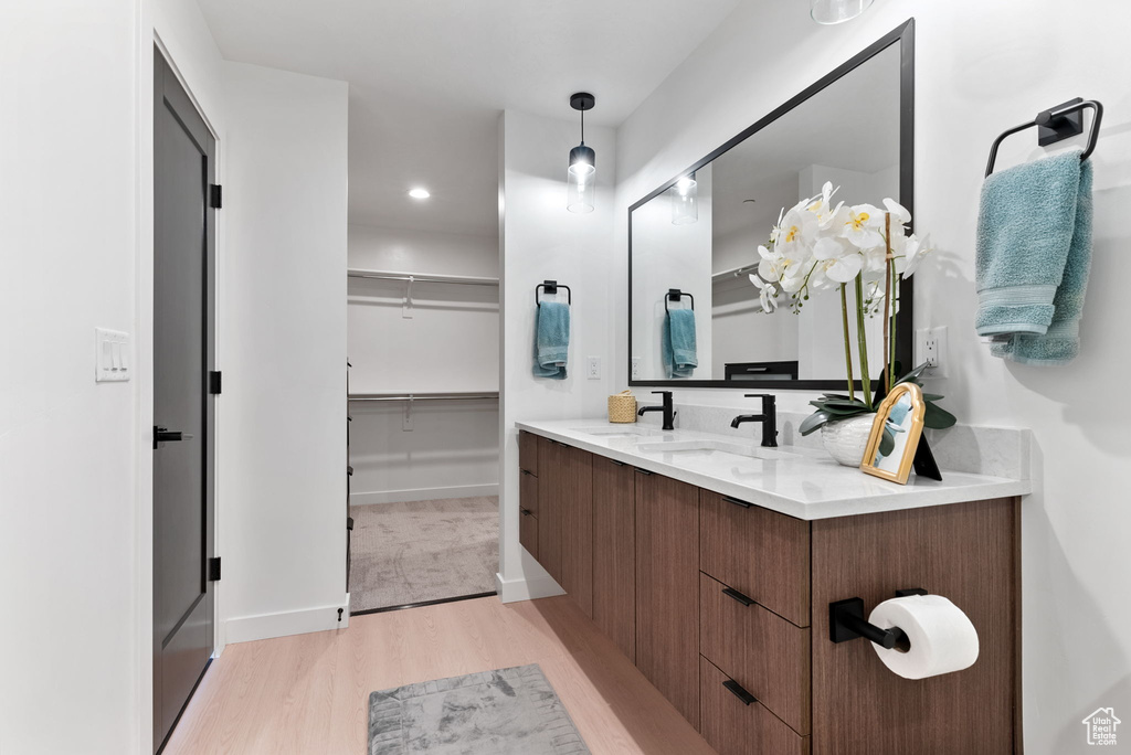 Bathroom featuring hardwood / wood-style flooring and vanity