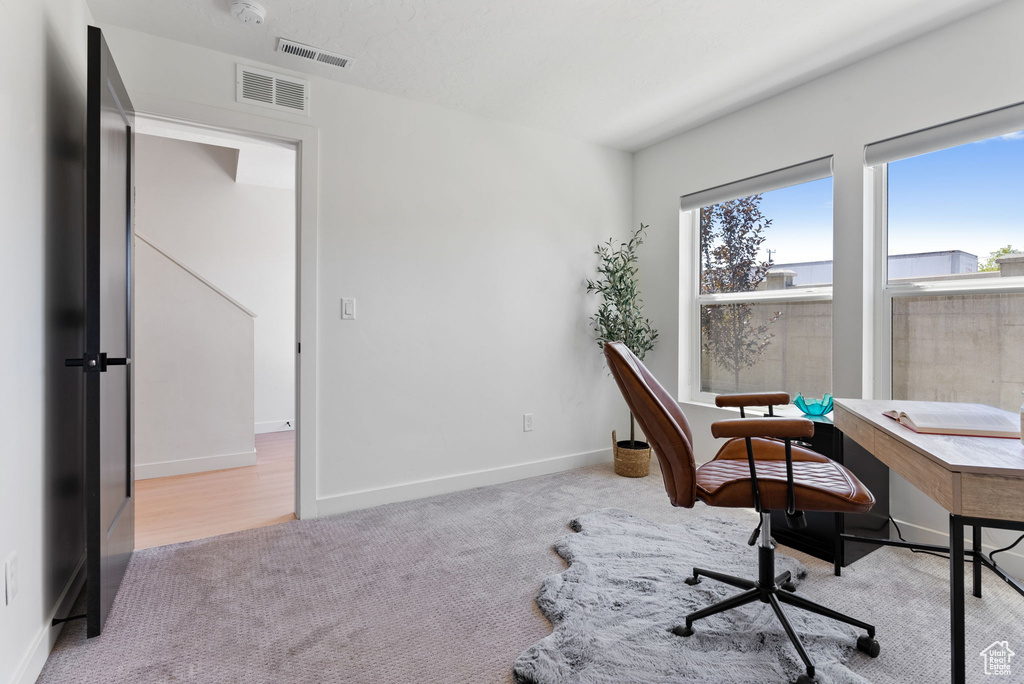 Home office with light wood-type flooring