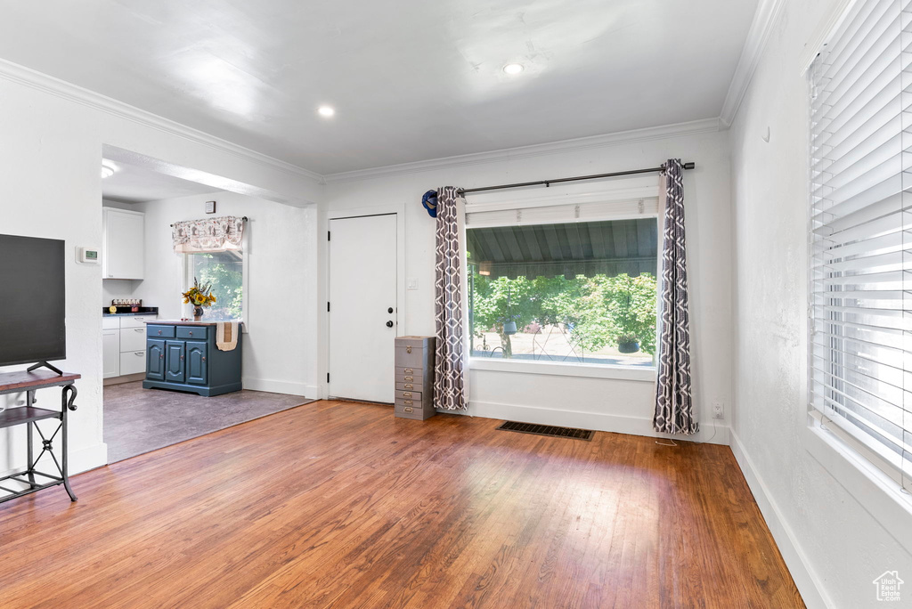 Living room featuring ornamental molding and hardwood / wood-style flooring