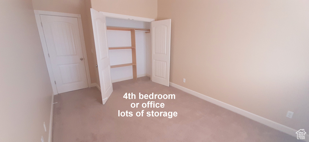 Unfurnished bedroom with a closet and carpet floors