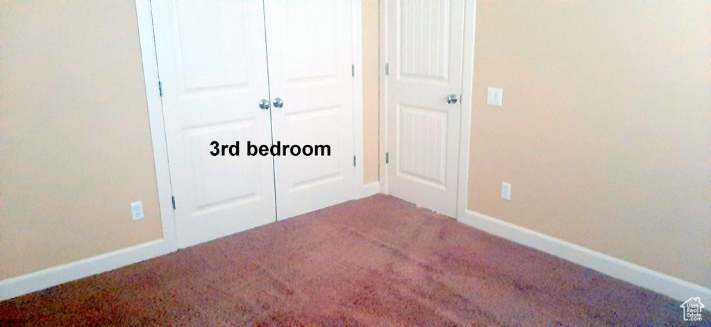 Unfurnished bedroom with carpet and a closet