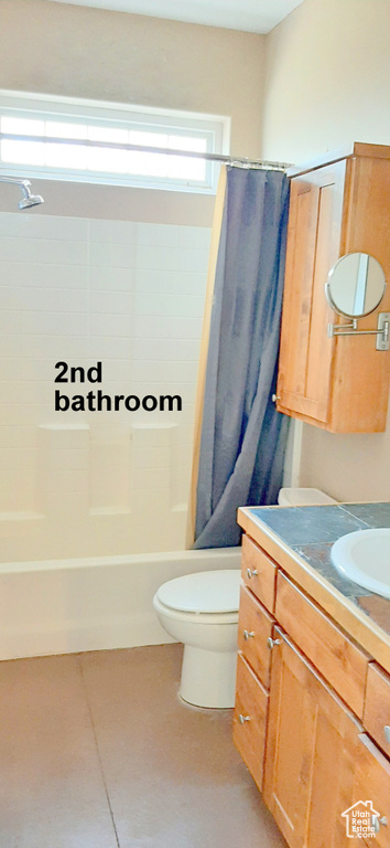 Full bathroom with tile patterned flooring, toilet, shower / bathtub combination with curtain, and vanity