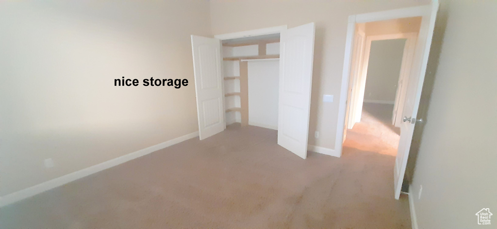 Unfurnished bedroom with a closet and carpet floors