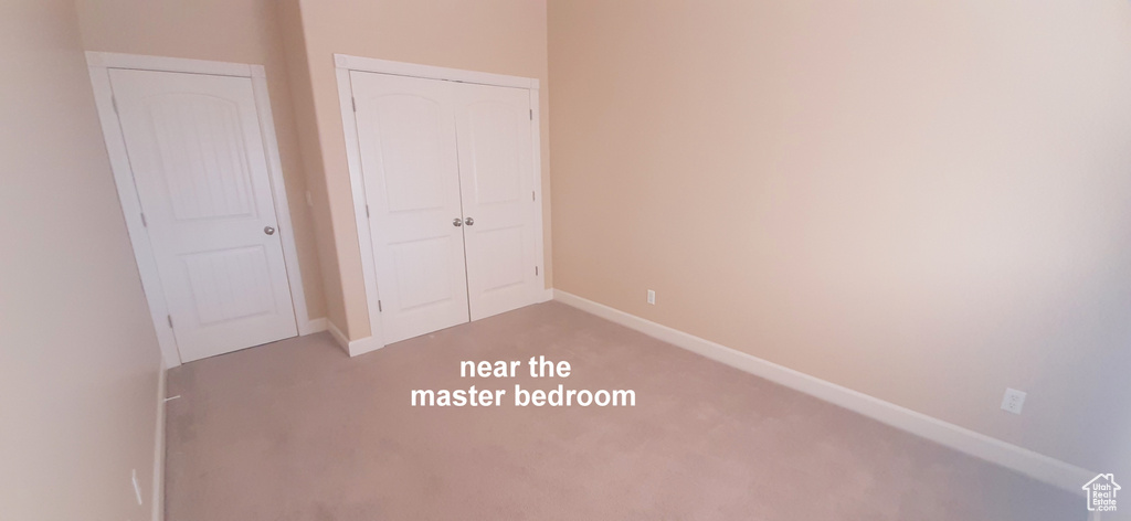 Unfurnished bedroom featuring a closet and carpet floors