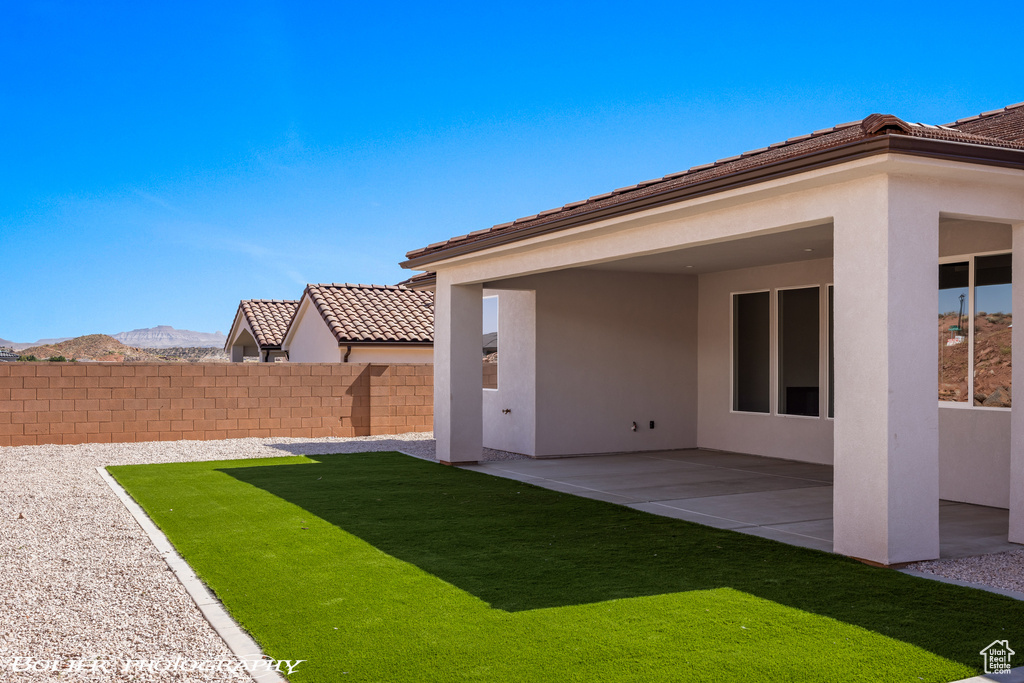 View of yard with a mountain view and a patio area