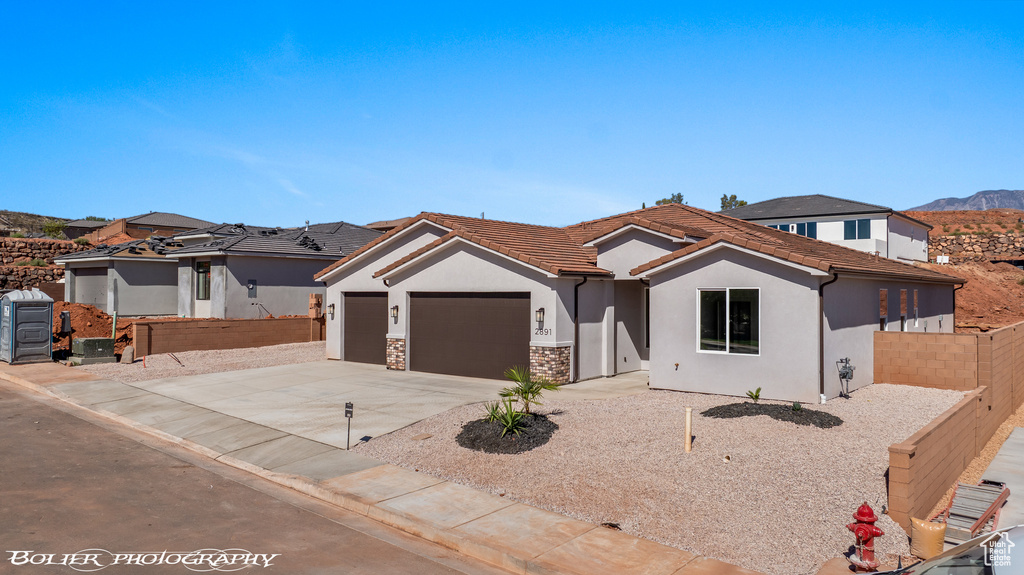 View of front facade with a mountain view and a garage