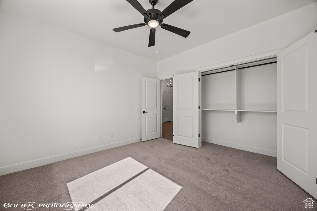 Unfurnished bedroom featuring light carpet, a closet, and ceiling fan