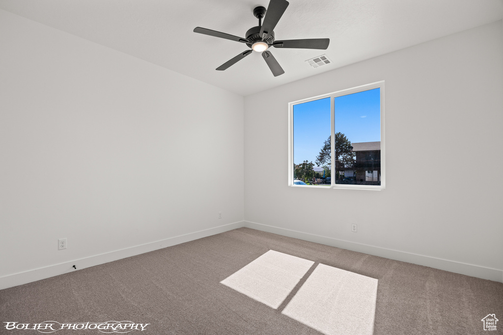 Unfurnished room with ceiling fan and carpet floors