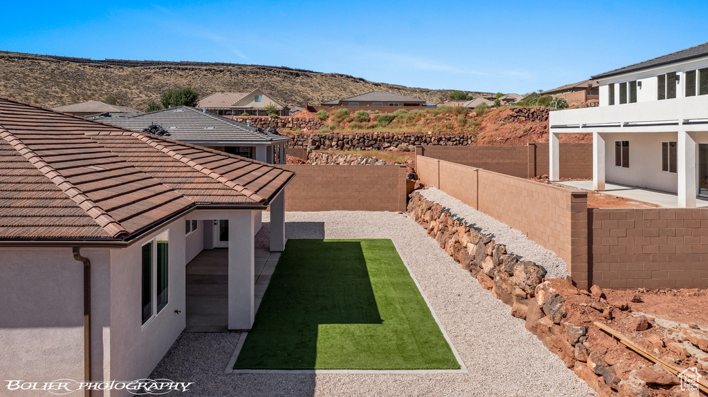 View of yard with a mountain view and a patio area