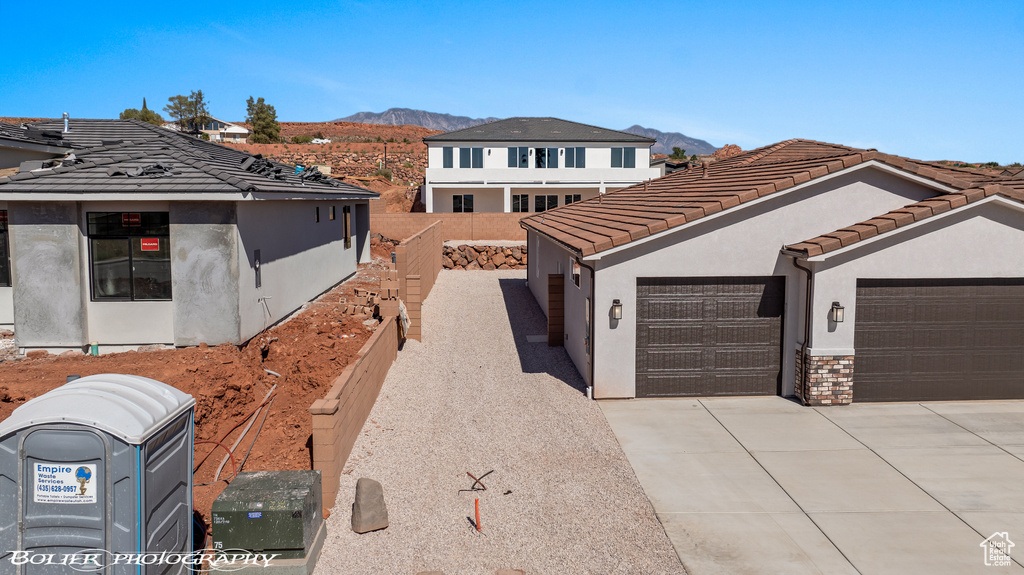 View of front facade with a mountain view and a garage